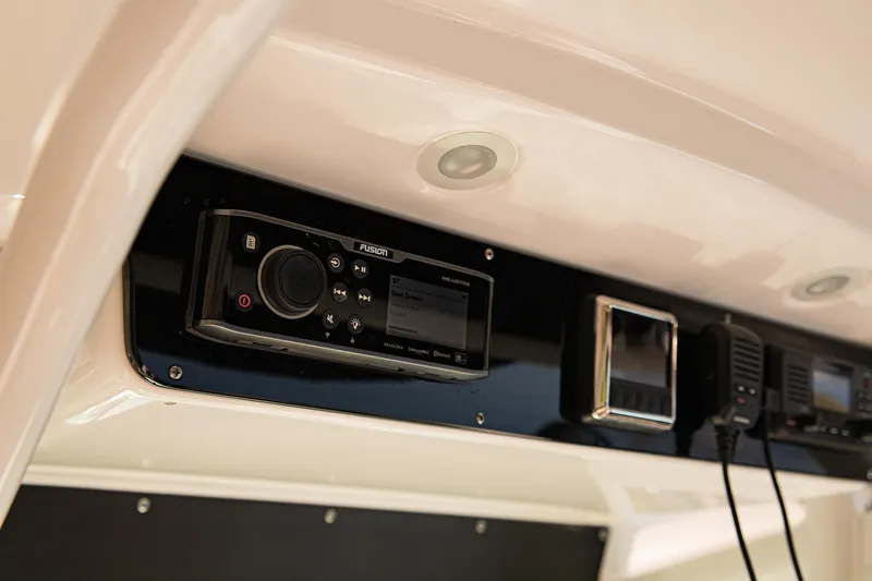 Slide: The Image of 2017 Everglades 253 Center Console dashboard with modern audio and communication equipment. - 20