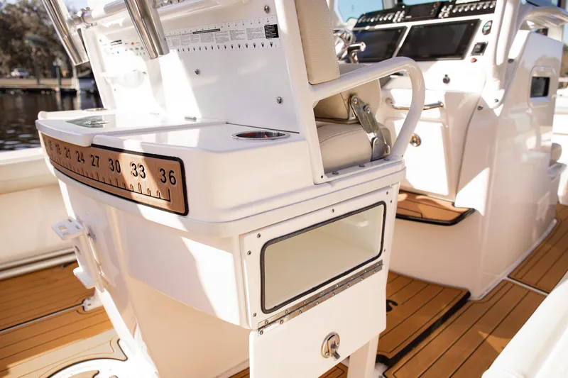 Slide: The Image of 2017 Everglades 253 Center Console boat interior with teak flooring and fishing equipment. - 21