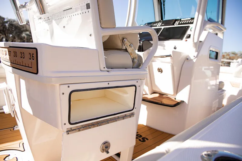 Slide: The Image of 2017 Everglades 253 Center Console boat interior with storage and seating. - 22