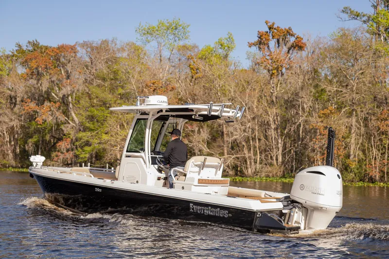Slide: The Image of 2017 Everglades 253 Center Console boat cruising on a scenic river. - 3