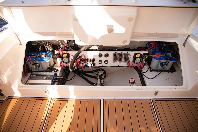 Slide: The Image of 2017 Everglades 253 Center Console boat battery compartment with wiring and components. - 31