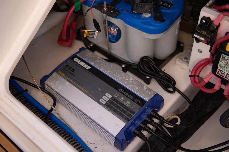 Slide: The Image of Battery and charger setup in a 2017 Everglades 253 Center Console boat. - 34