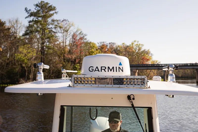 Slide: The Image of 2017 Everglades 253 Center Console with Garmin equipment on a calm river. - 37