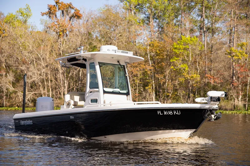 Slide: The Image of 2017 Everglades 253 Center Console boat cruising on a scenic waterway. - 4
