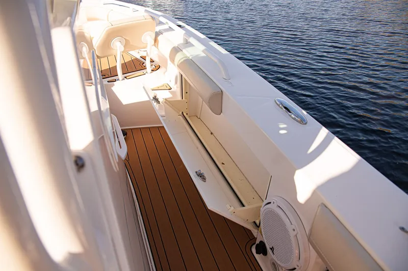 Slide: The Image of 2017 Everglades 253 Center Console boat with teak deck, docked on calm water. - 42