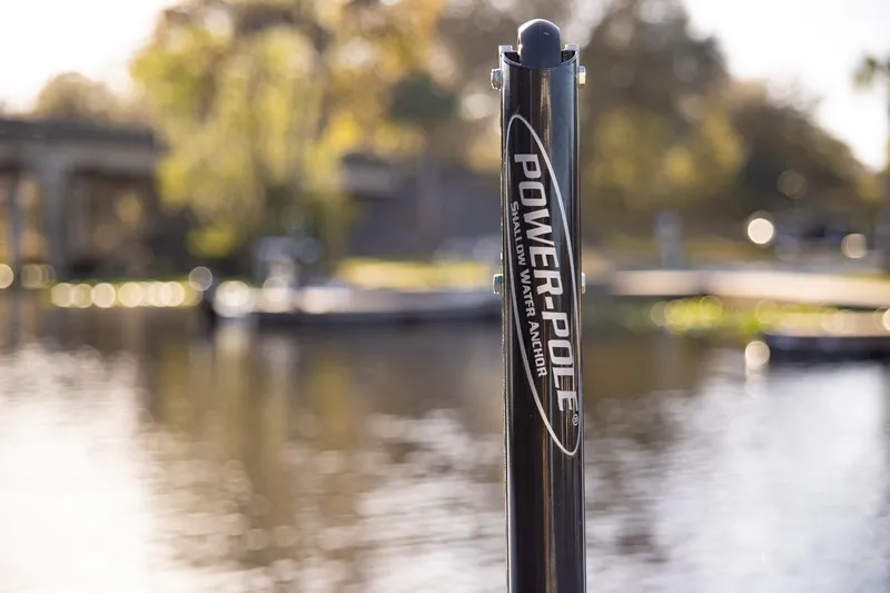 Slide: The Image of Power-Pole anchor on Everglades 253 Center Console, 2017, near a serene waterfront. - 45
