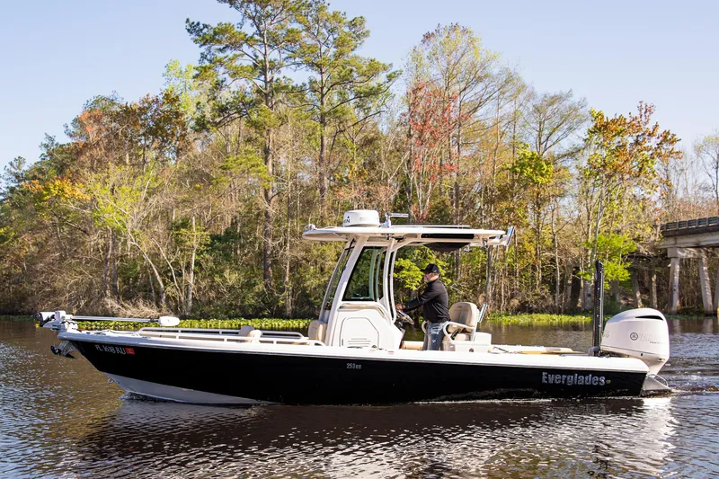 Slide: The Image of 2017 Everglades 253 Center Console boat cruising on a scenic river. - 5