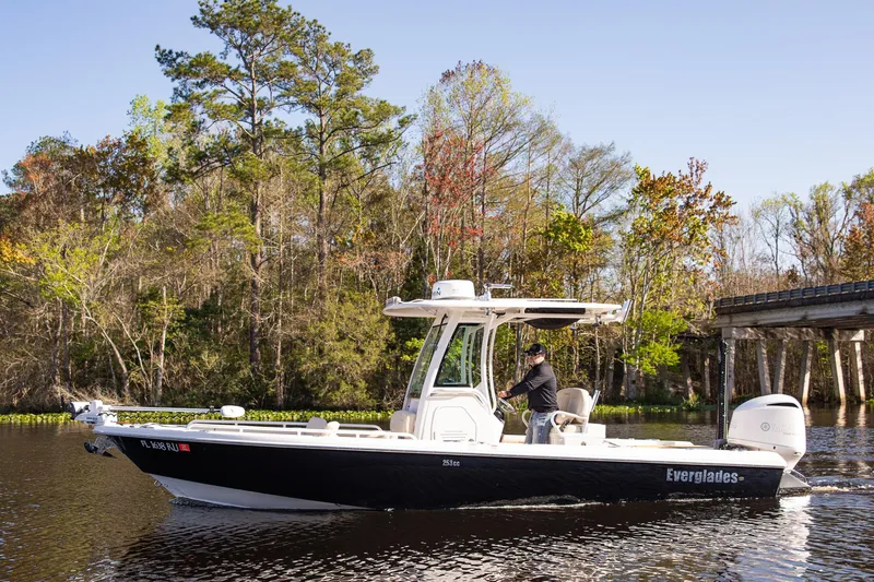 Slide: The Image of 2017 Everglades 253 Center Console boat cruising on a scenic river. - 6