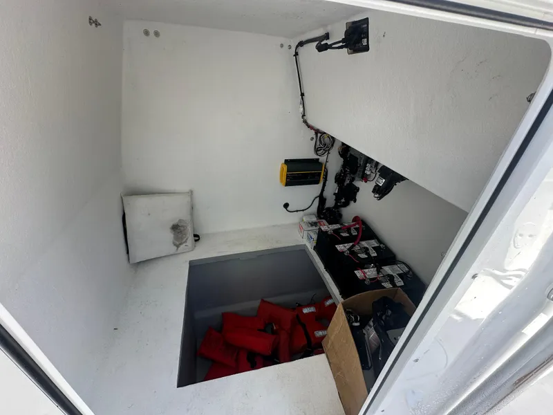 Slide: The Image of Storage compartment of 2025 AmeraCat 395 boat with equipment and life jackets. - 10