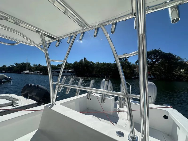 Slide: The Image of 2025 AmeraCat 395 boat with sleek design, rod holders, and scenic waterfront view. - 13