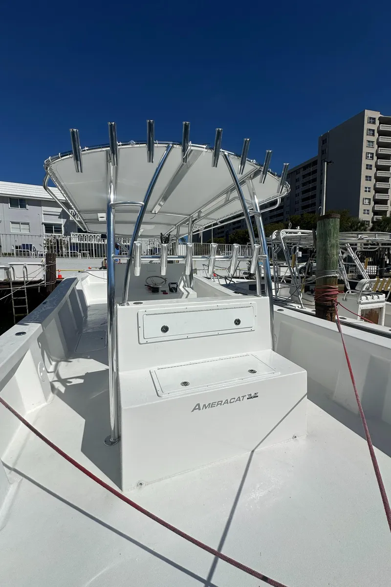 Slide: The Image of 2025 AmeraCat 395 boat with sleek design and modern features, docked under clear blue sky. - 18