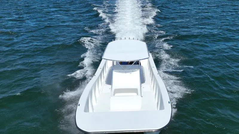 Slide: The Image of 2025 AmeraCat 395 boat cruising on open water, aerial view. - 6