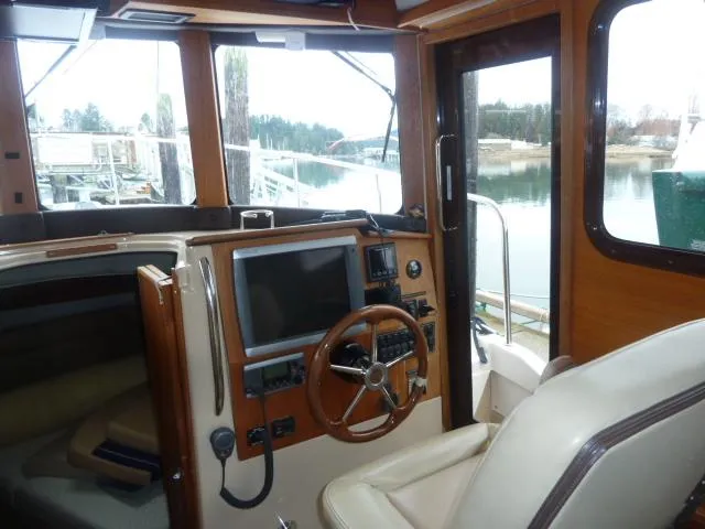 Slide: The Image of Interior of 2013 Ranger Tugs R-31 boat with steering wheel and navigation equipment. - 10