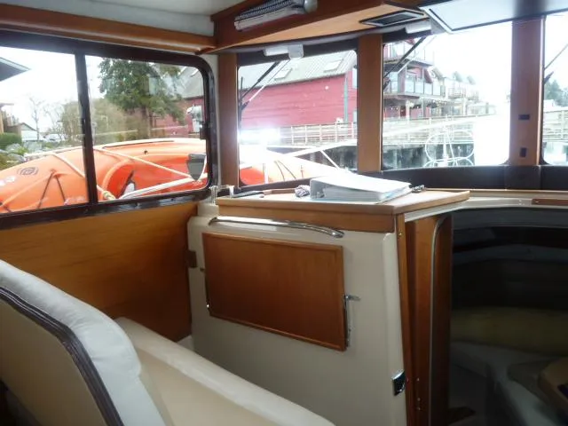 Slide: The Image of Interior of 2013 Ranger Tugs R-31 boat with wooden cabinetry and seating. - 11