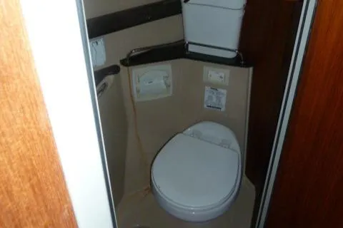 Slide: The Image of 2013 Ranger Tugs R-31 boat bathroom interior with toilet and storage. - 14