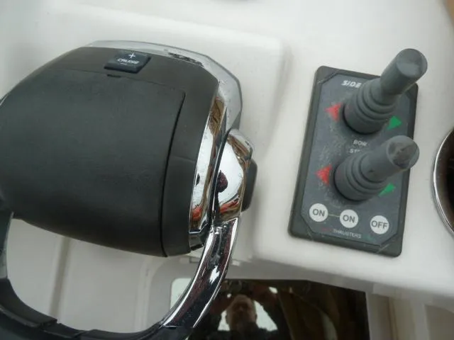 Slide: The Image of Control panel of 2013 Ranger Tugs R-31 boat with throttle and joystick controls. - 18