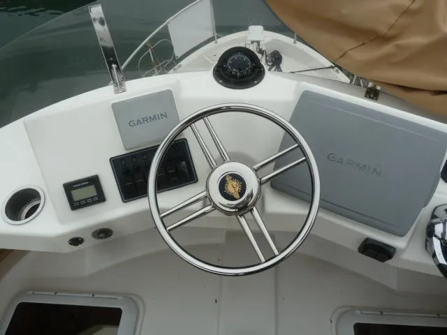 Slide: The Image of Steering wheel and Garmin navigation on 2013 Ranger Tugs R-31 boat dashboard. - 19
