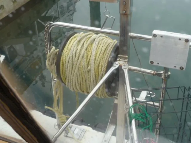 Slide: The Image of Ranger Tugs R-31 (2013) boat with coiled rope on deck near water. - 23