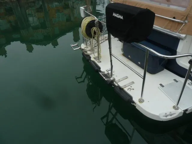 Slide: The Image of 2013 Ranger Tugs R-31 boat stern with equipment and calm water reflection. - 24
