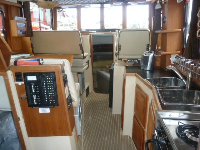 Slide: The Image of Interior of 2013 Ranger Tugs R-31 boat with kitchen and seating area. - 6