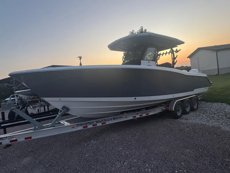The Image of 2022 Crevalle 33 CSF boat on trailer at sunset, side view. - 0