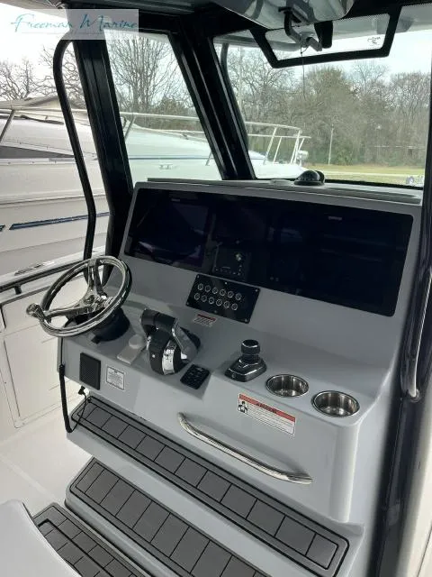 Slide: The Image of 2022 Crevalle 33 CSF boat cockpit with steering wheel and control panel. - 16