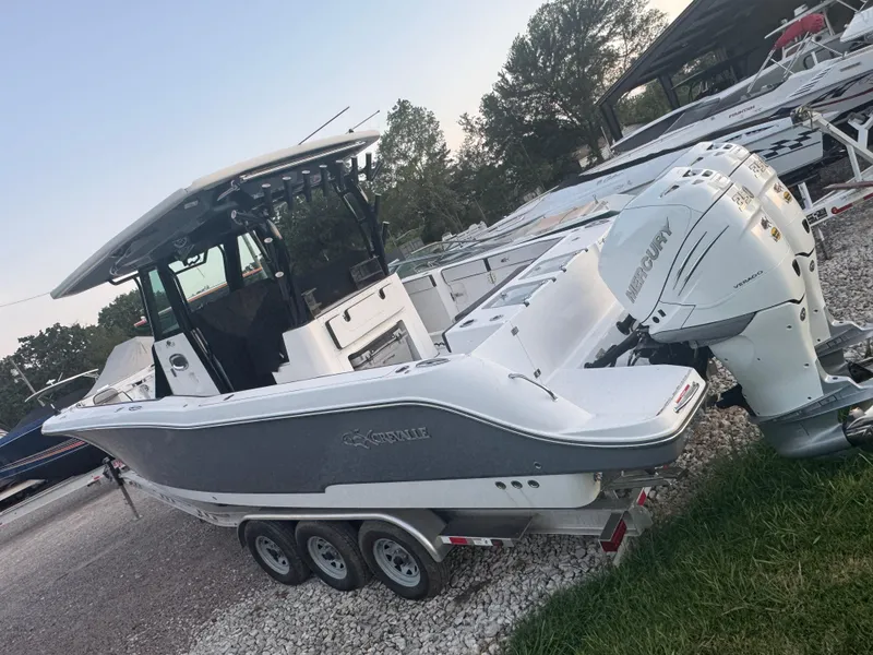 Slide: The Image of 2022 Crevalle 33 CSF boat with Mercury outboard engines on a trailer. - 2