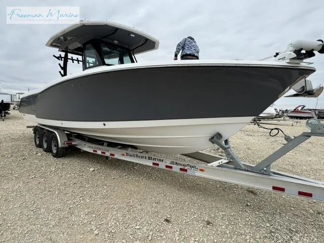 Slide: The Image of 2022 Crevalle 33 CSF boat on trailer, displayed outdoors. - 4