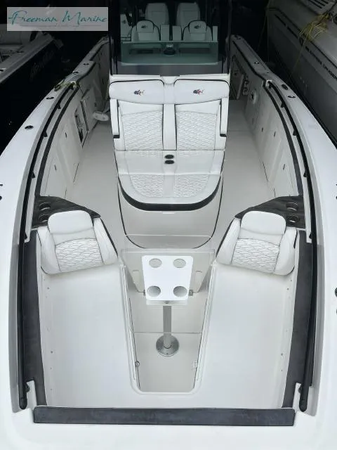 Slide: The Image of 2022 Crevalle 33 CSF boat interior with white seating and table setup. - 5