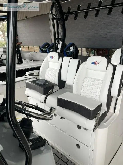 Slide: The Image of 2022 Crevalle 33 CSF boat interior with white cushioned seating and modern design. - 7