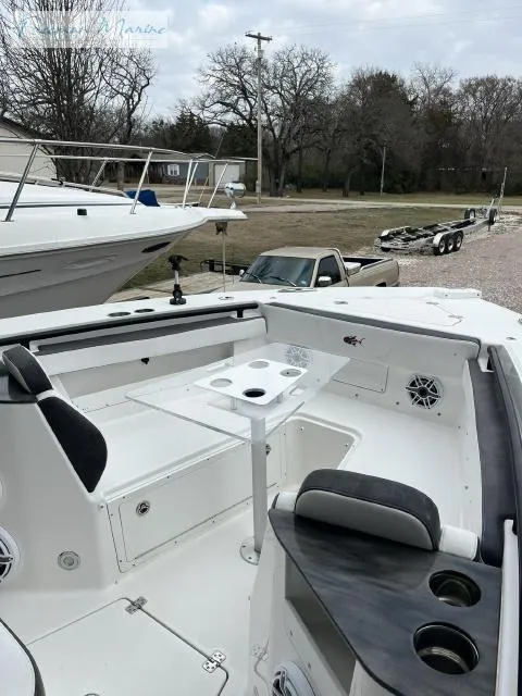Slide: The Image of 2022 Crevalle 33 CSF boat with seating and table, parked outdoors. - 9