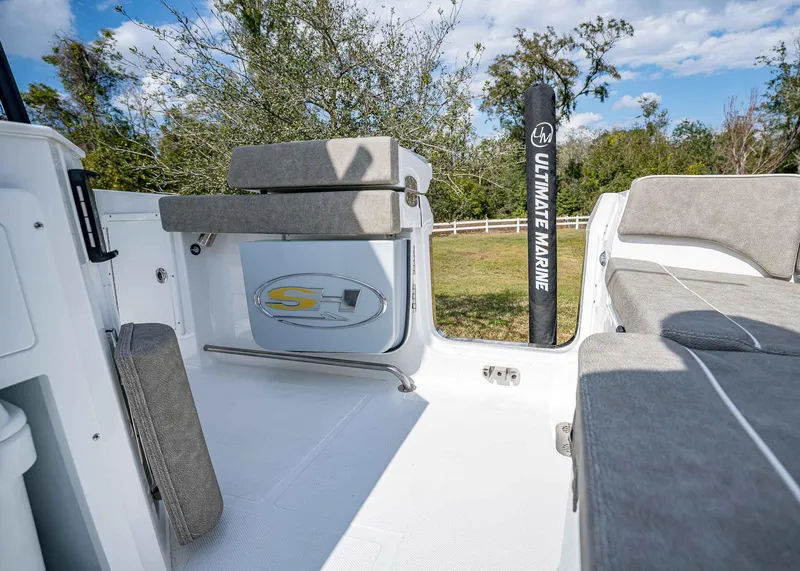Slide: The Image of 2025 Sea Hunt Ultra 275 SE boat interior with gray seating and Ultimate Marine branding. - 12
