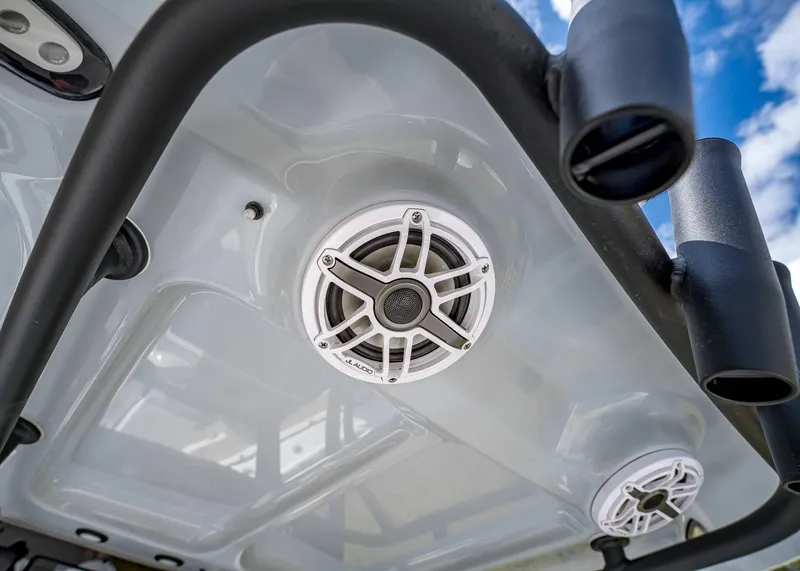 Slide: The Image of 2025 Sea Hunt Ultra 275 SE boat speakers and rod holders against a blue sky. - 19