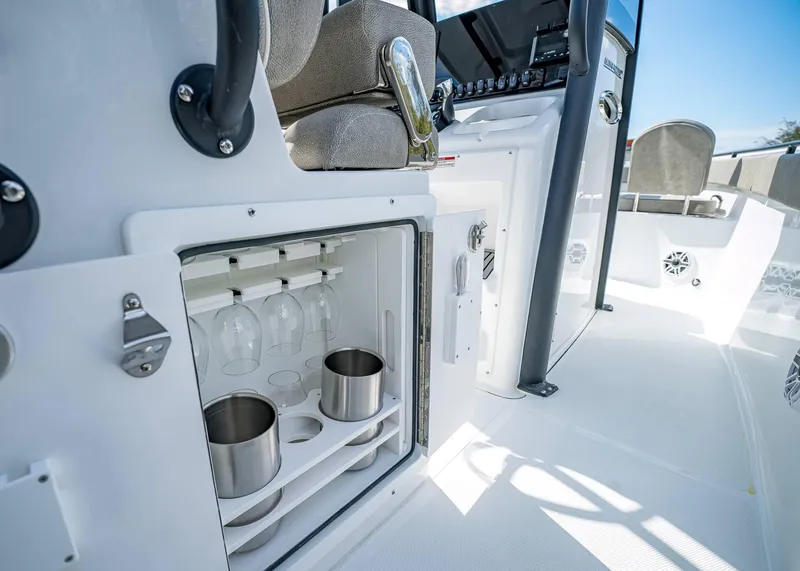 Slide: The Image of 2025 Sea Hunt Ultra 275 SE boat interior with glass and cup storage. - 21