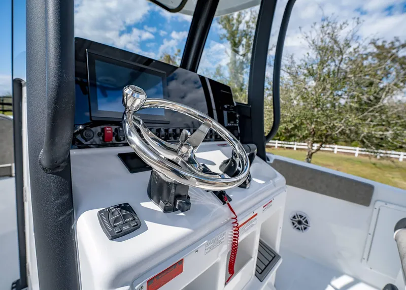 Slide: The Image of 2025 Sea Hunt Ultra 275 SE boat helm with modern controls and steering wheel. - 26