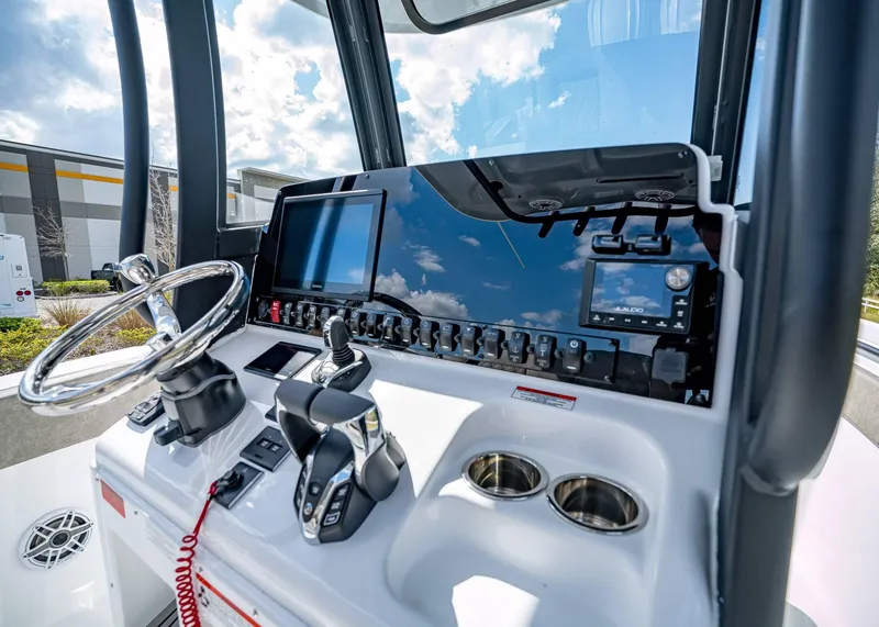 Slide: The Image of 2025 Sea Hunt Ultra 275 SE boat dashboard with steering wheel and control panel. - 29