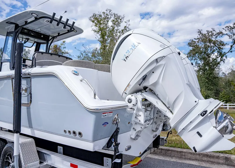 Slide: The Image of 2025 Sea Hunt Ultra 275 SE boat with Yamaha outboard engine on trailer. - 3