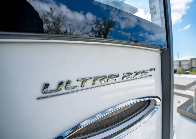 Slide: The Image of 2025 Sea Hunt Ultra 275 SE boat emblem with reflective chrome finish. - 31