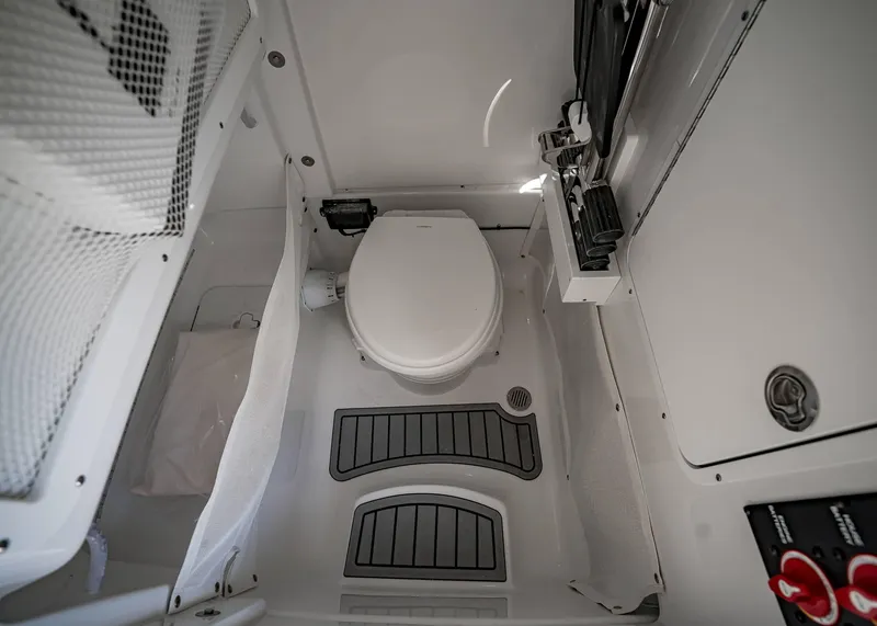 Slide: The Image of 2025 Sea Hunt Ultra 275 SE boat interior with toilet and storage features. - 33