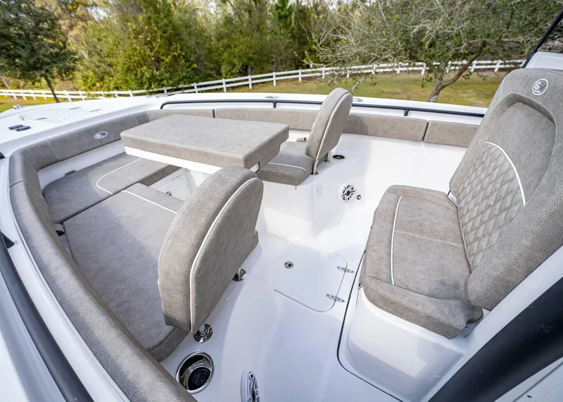 Slide: The Image of 2025 Sea Hunt Ultra 275 SE boat interior with cushioned seating and table. - 35