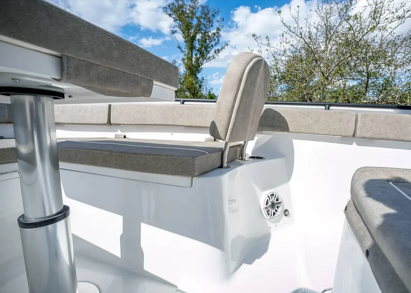 Slide: The Image of 2025 Sea Hunt Ultra 275 SE boat interior with cushioned seating and speaker. - 37