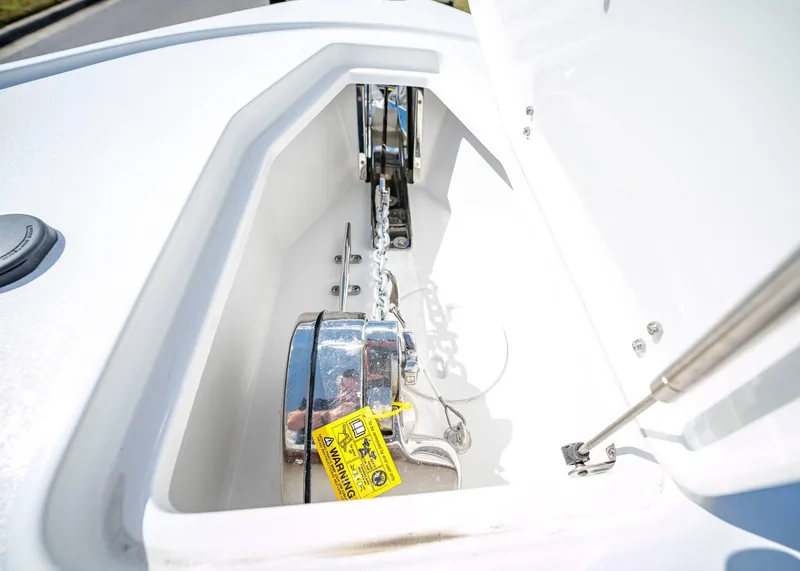 Slide: The Image of Anchor compartment of 2025 Sea Hunt Ultra 275 SE boat, featuring a chain and winch. - 40