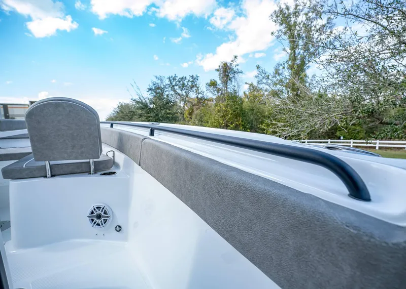 Slide: The Image of 2025 Sea Hunt Ultra 275 SE boat interior with seating and speaker, under blue sky. - 42