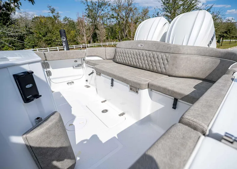Slide: The Image of 2025 Sea Hunt Ultra 275 SE boat interior with cushioned seating and dual engines. - 7