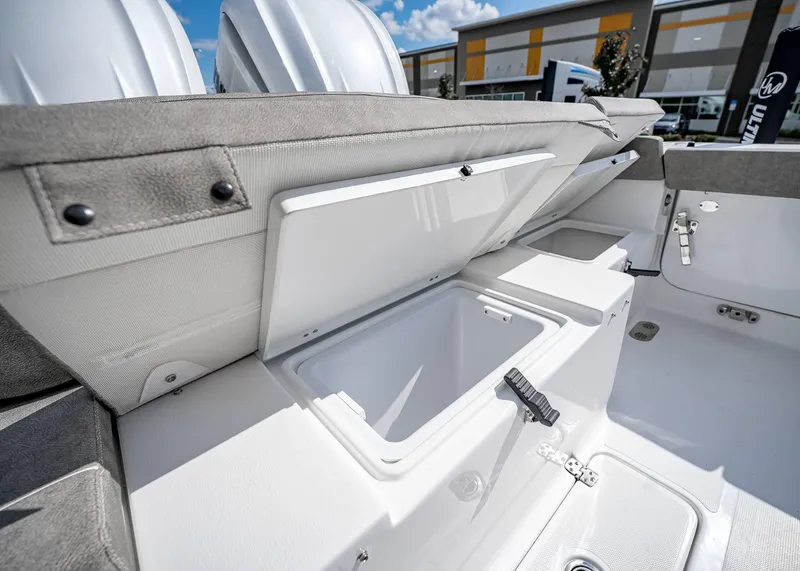 Slide: The Image of 2025 Sea Hunt Ultra 275 SE boat storage compartments open, showcasing interior space. - 9