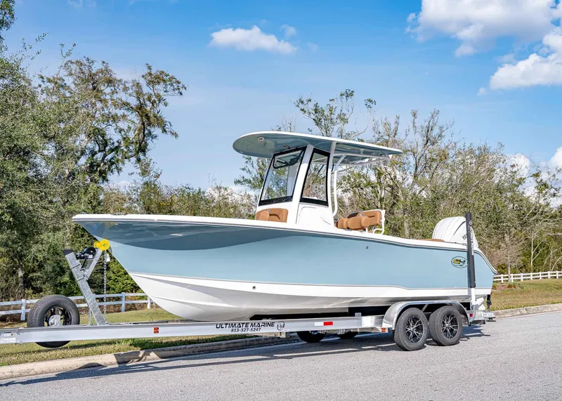 Slide: The Image of 2025 Sea Hunt Ultra 235 SE boat on trailer, parked outdoors. - 1