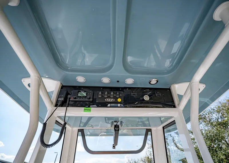 Slide: The Image of 2025 Sea Hunt Ultra 235 SE boat console with electronics and overhead view. - 18