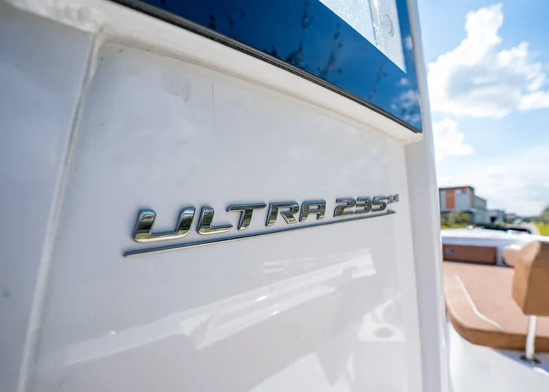 Slide: The Image of 2025 Sea Hunt Ultra 235 SE boat emblem in sunlight. - 21