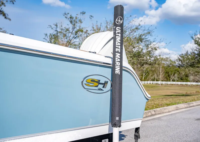 Slide: The Image of 2025 Sea Hunt Ultra 235 SE boat with Ultimate Marine branding on a sunny day. - 3