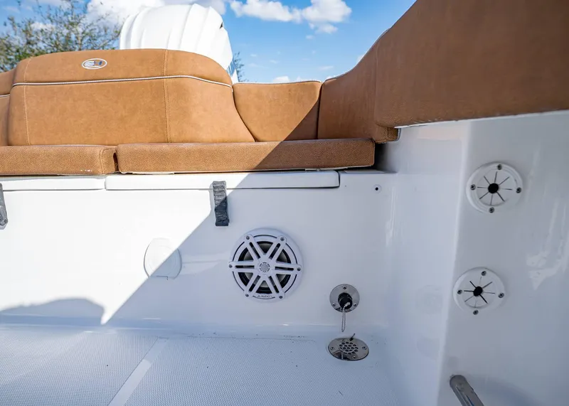 Slide: The Image of 2025 Sea Hunt Ultra 235 SE boat interior with tan seating and speaker system. - 8